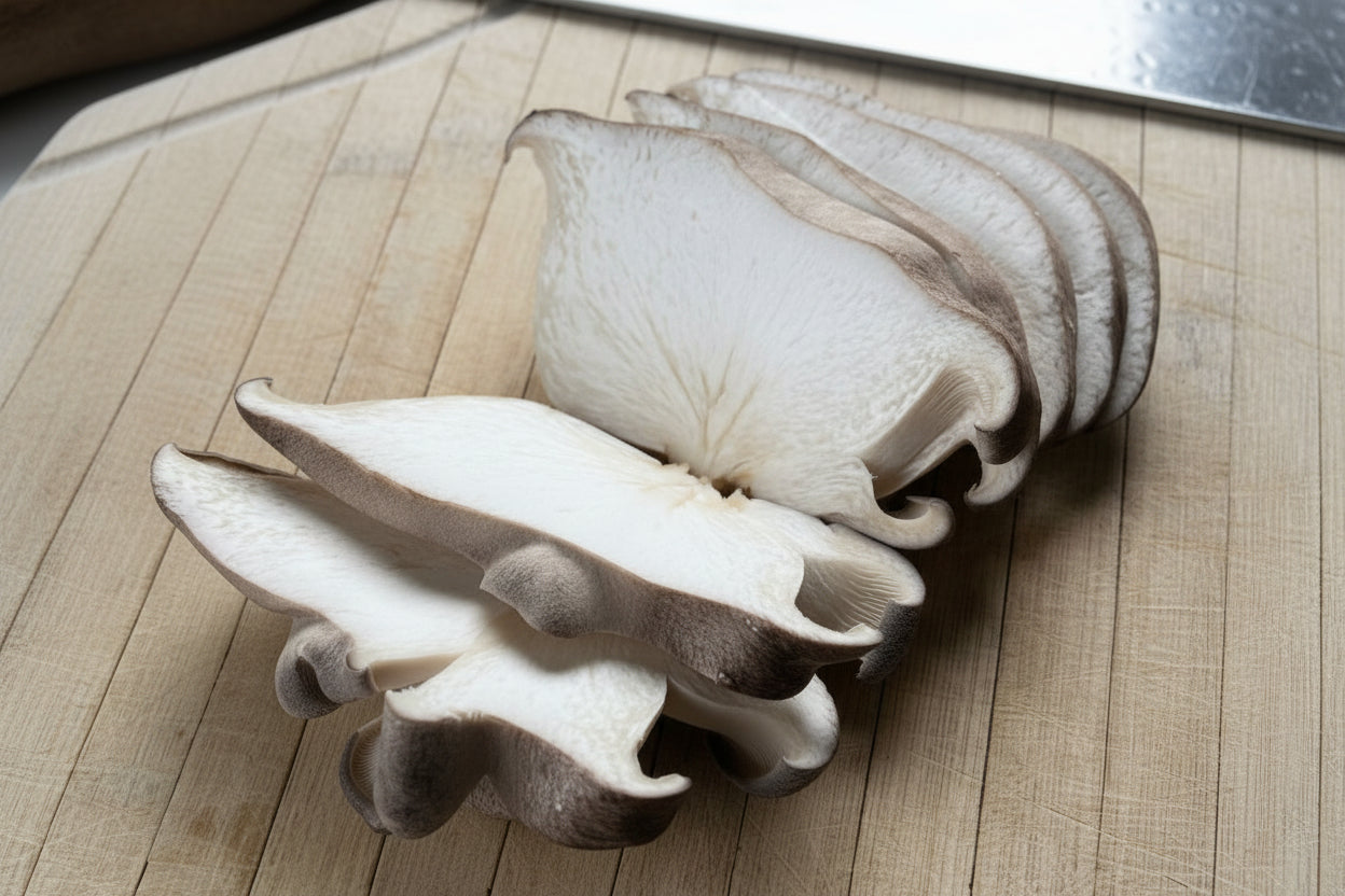 Sliced mushrooms on a wooden cutting board